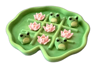Tic Tac Toad pond game with lily pad board, frog pieces, and flower markers